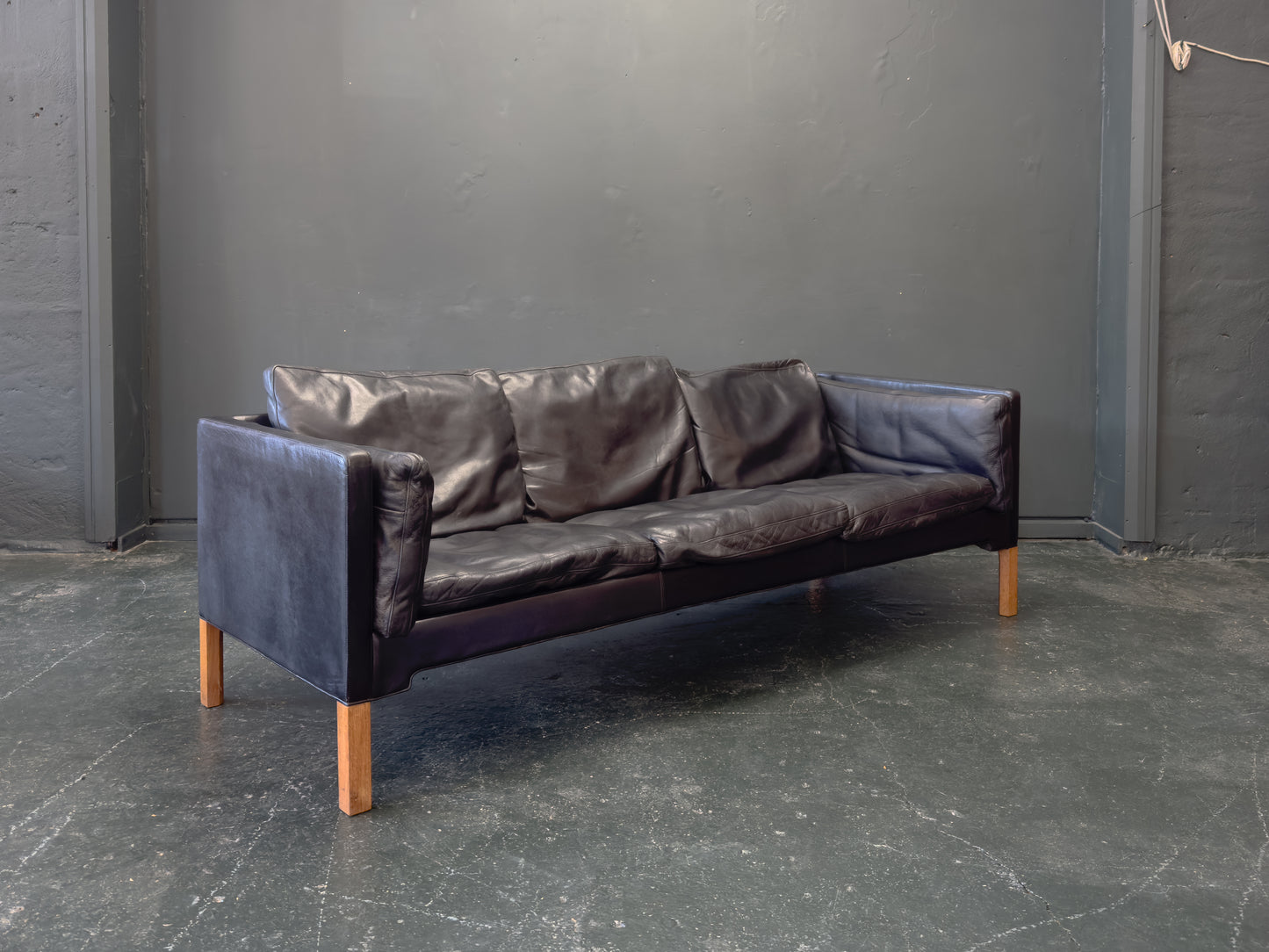 Black Leather Three-Seater Sofa