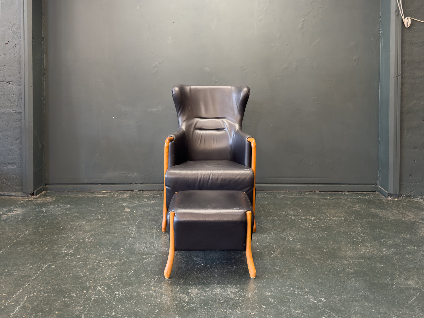 'Claudia' Black Leather and Beech Highback Armchair with Footstool by Stouby