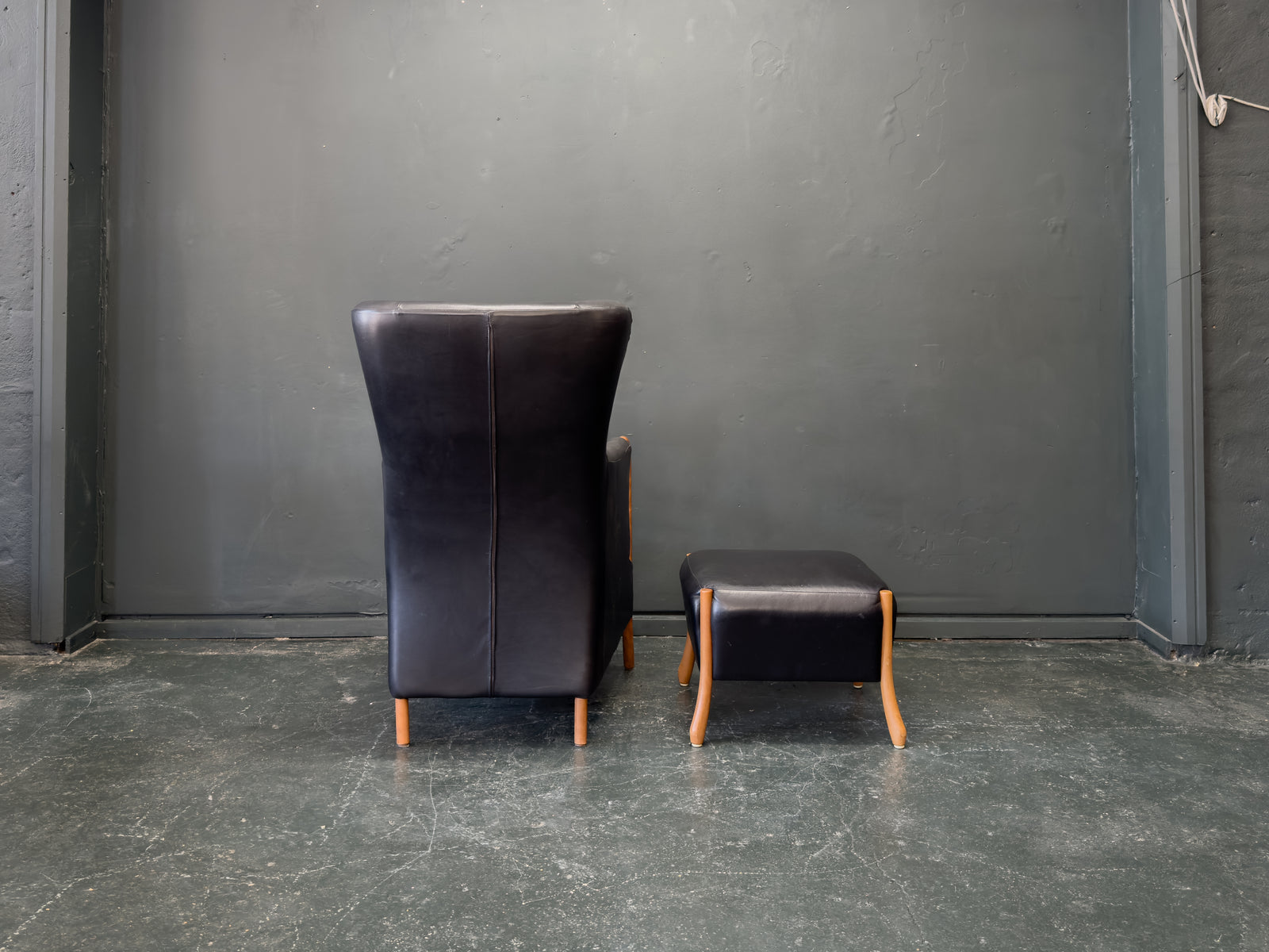'Claudia' Black Leather and Beech Highback Armchair with Footstool by Stouby
