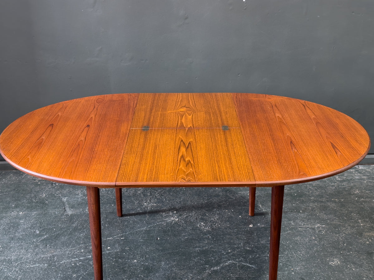 Round Teak Dining Table with Hinged Extending Leaf